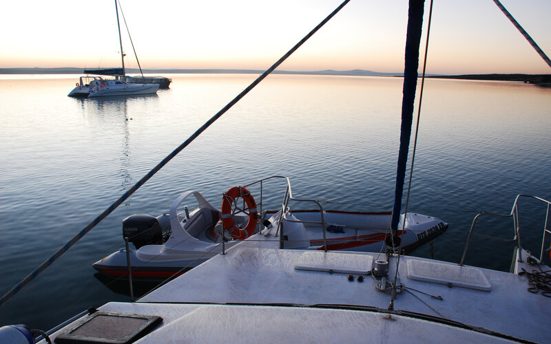 Sailboat at sunset on calm water