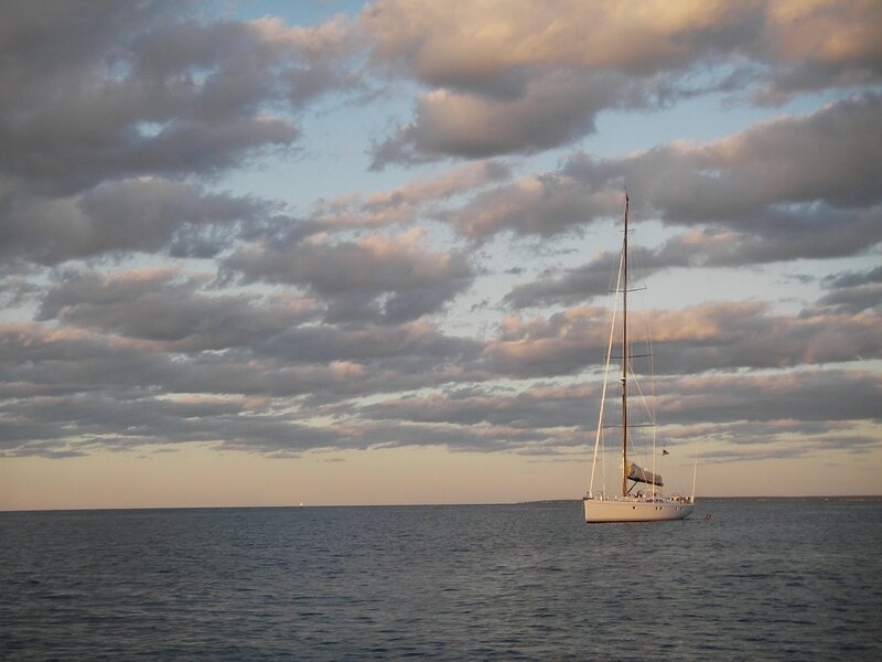 Sailboat at sunset on calm water
