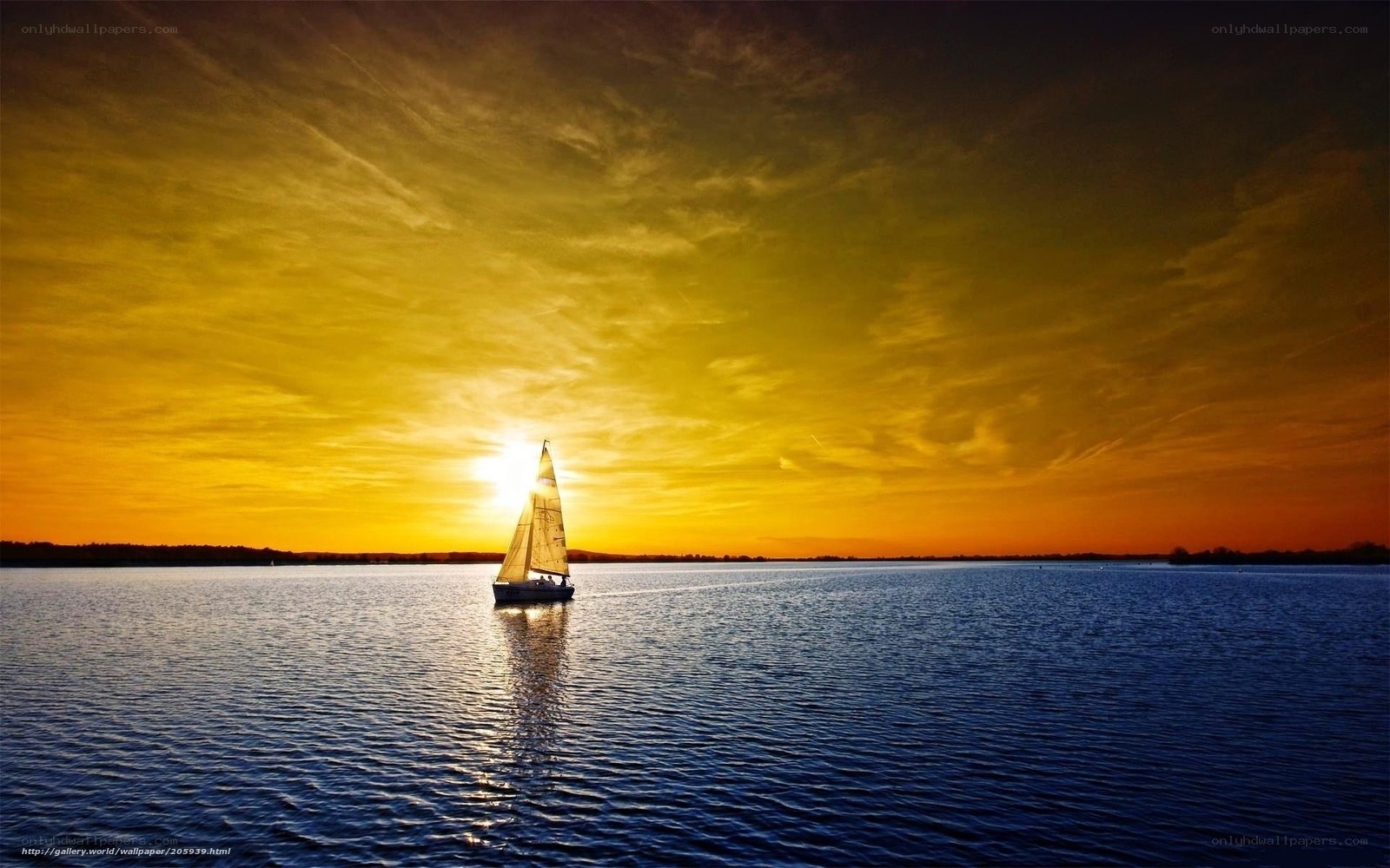 sailboat at sunset on calm water
