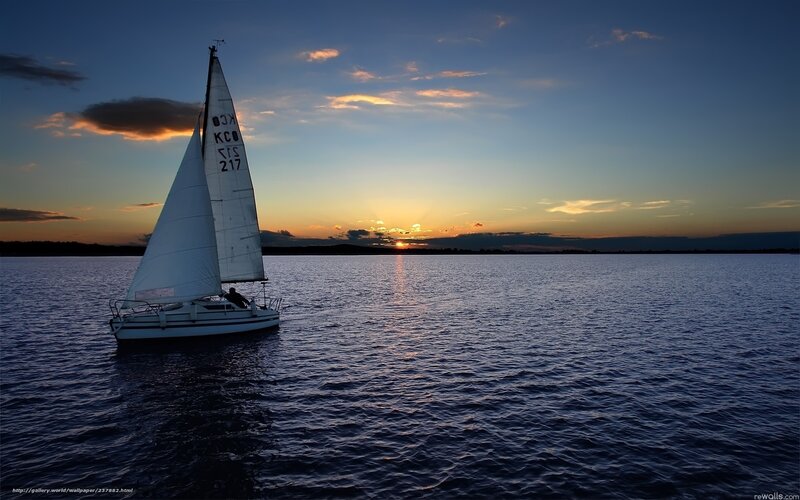 Sailboat at sunset on calm water