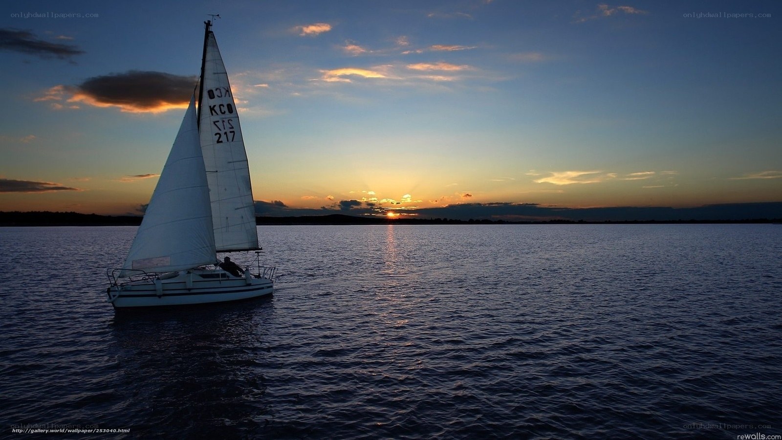Sailboat at sunset on calm water
