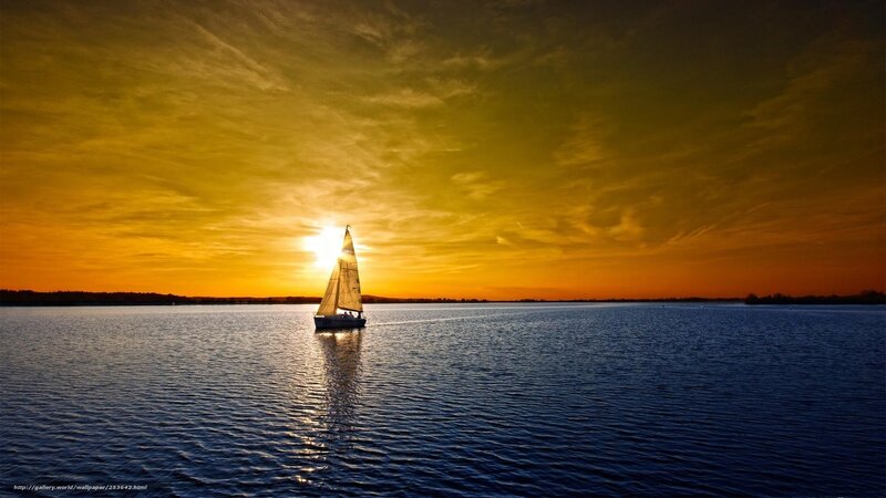 Sailboat at sunset on calm water