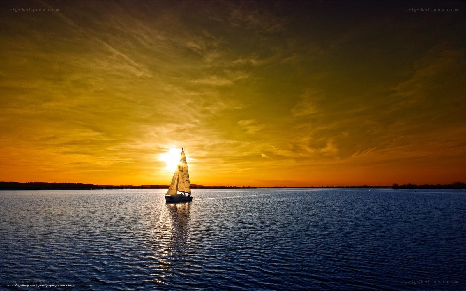 Sailboat at sunset on calm water