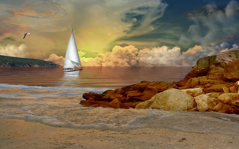 Sailboat at sunset on rocky beach