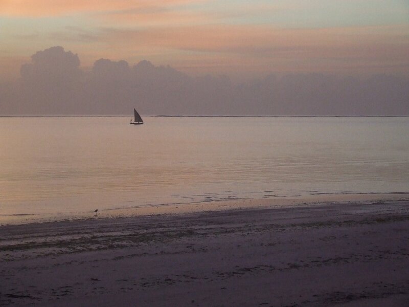 sailboat at sunset on the beach