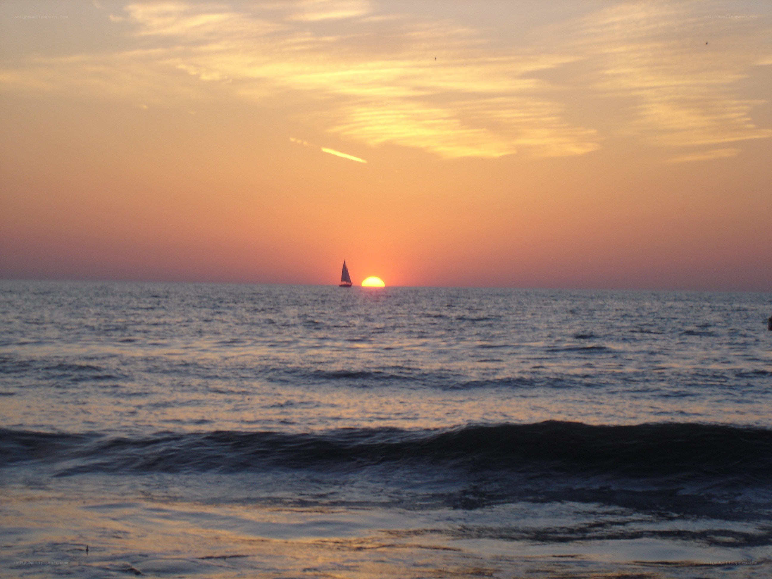 sailboat at sunset on the ocean