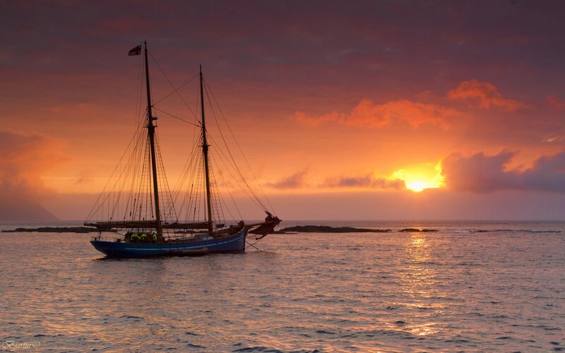 Sailboat at Sunset — Orange, Serene, Photograph, Sun, Ocean, Sky, Rocks