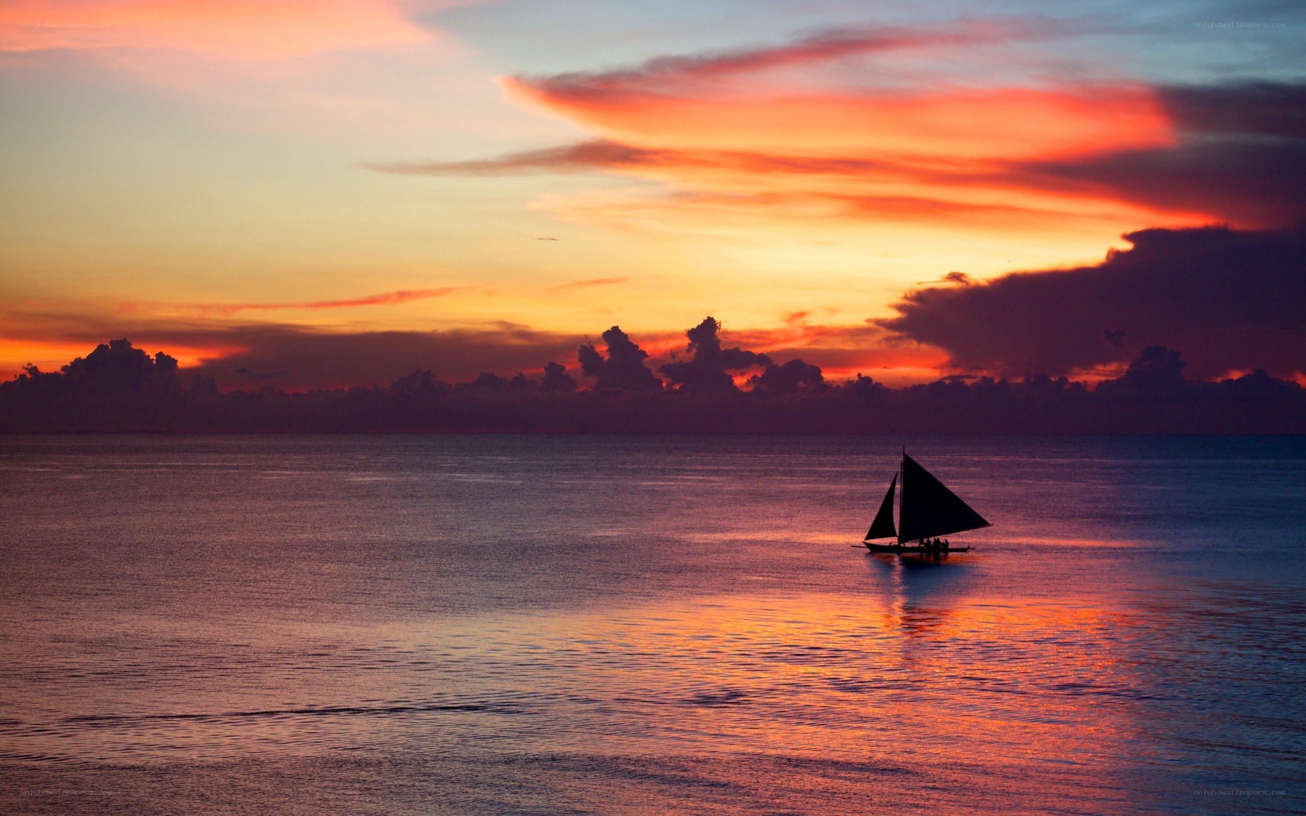 sailboat at sunset over ocean