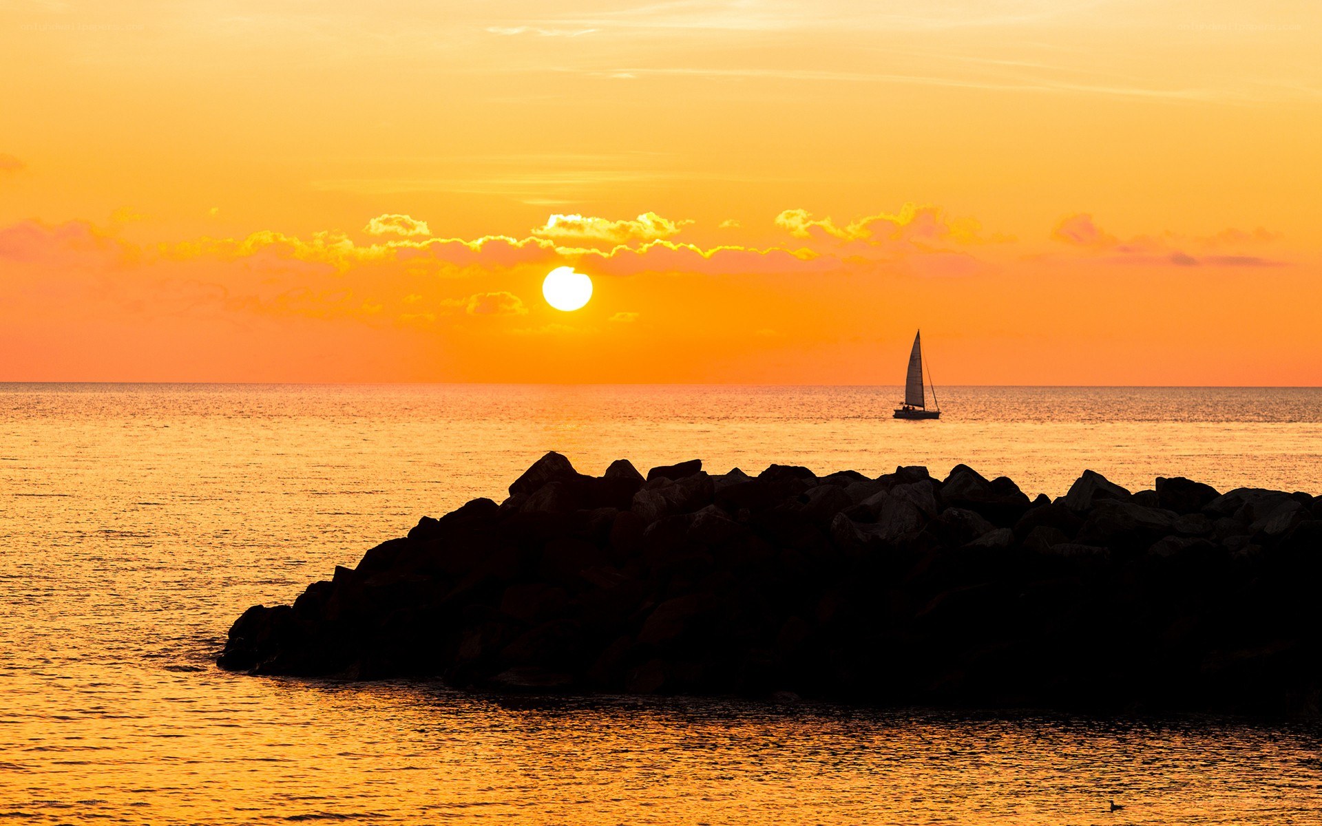 sailboat at sunset over water