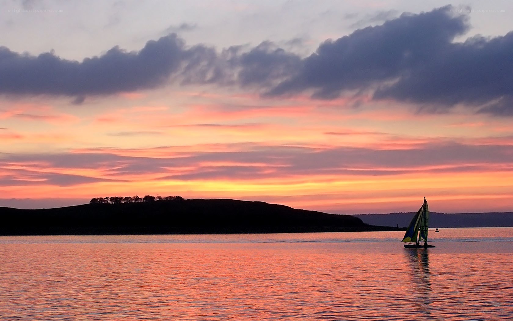 sailboat at sunset over water