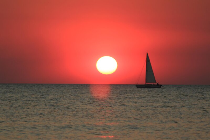 Sailboat at Sunset — Red, Serene, Photograph, Sun