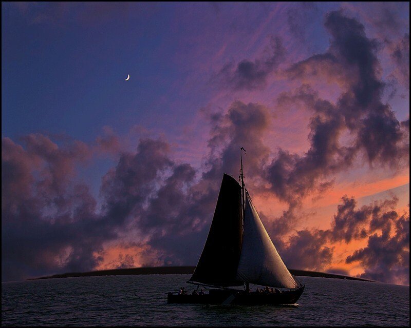 Sailboat at sunset with crescent moon