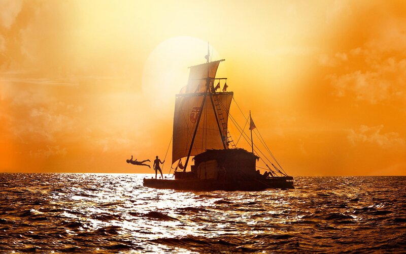 sailboat at sunset with people