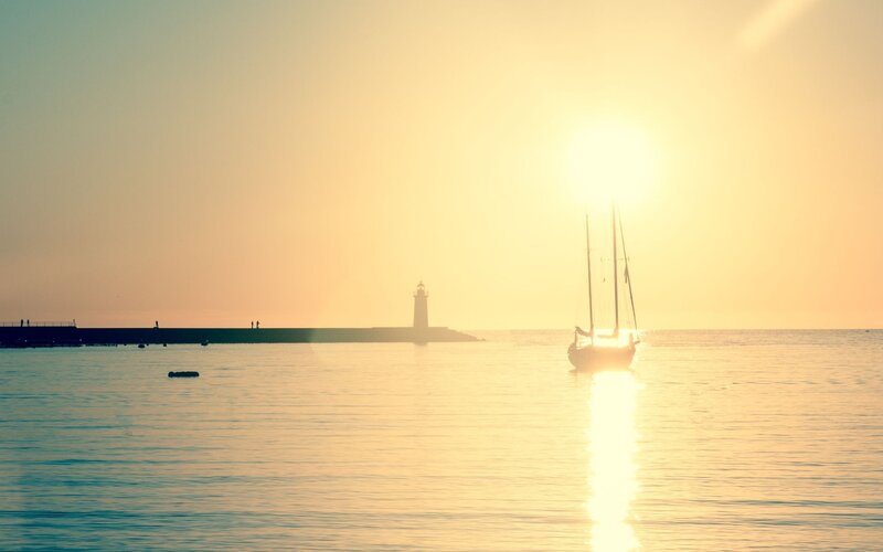 Sailboat at Sunset — Yellow, Serene, Photograph, Lighthouse