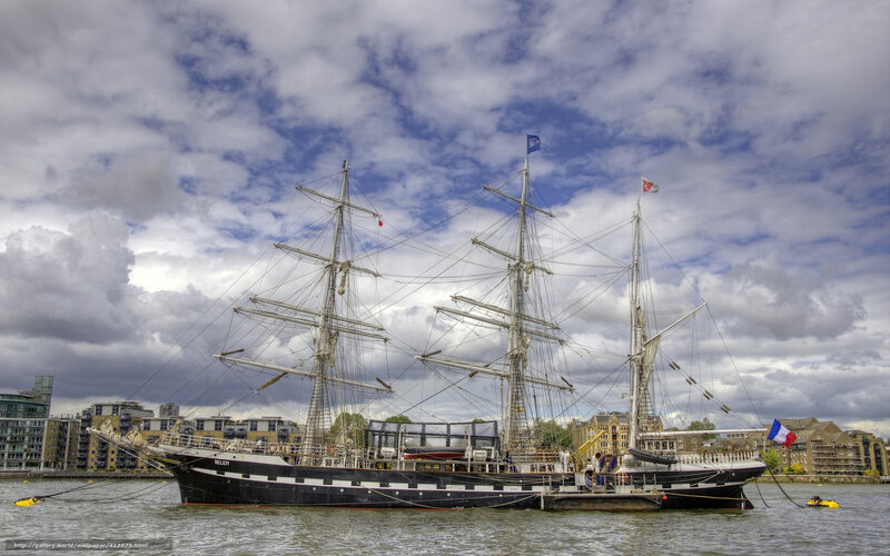 sailboat docked in city harbor