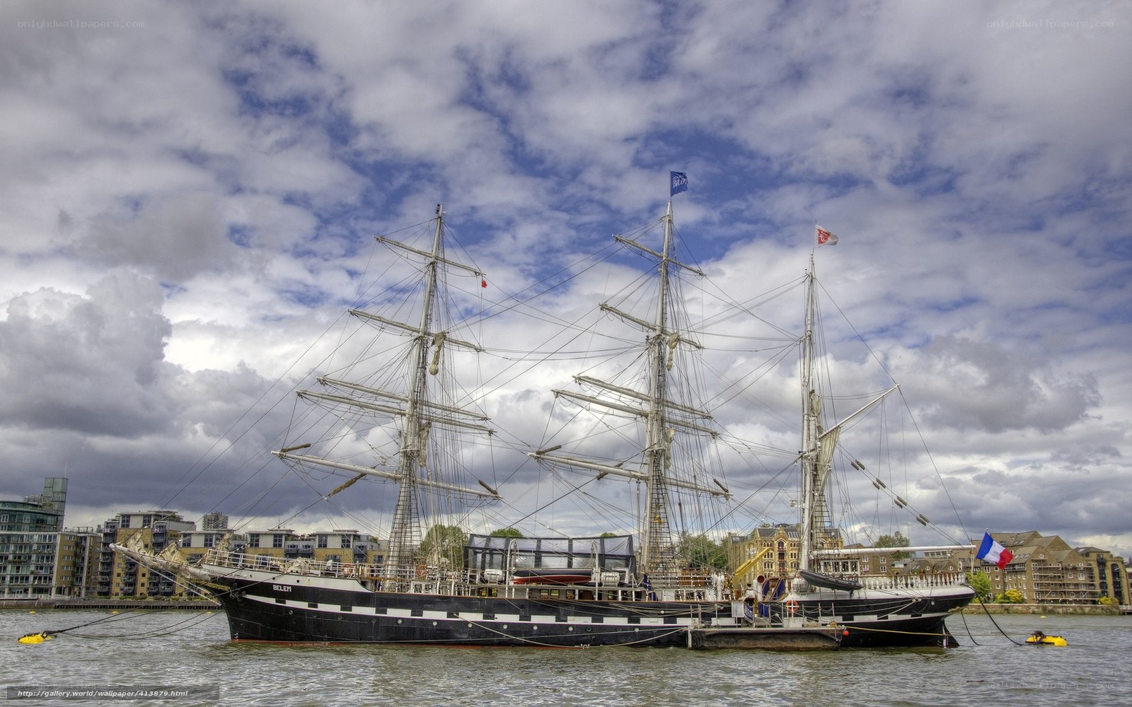 sailboat docked in city harbor