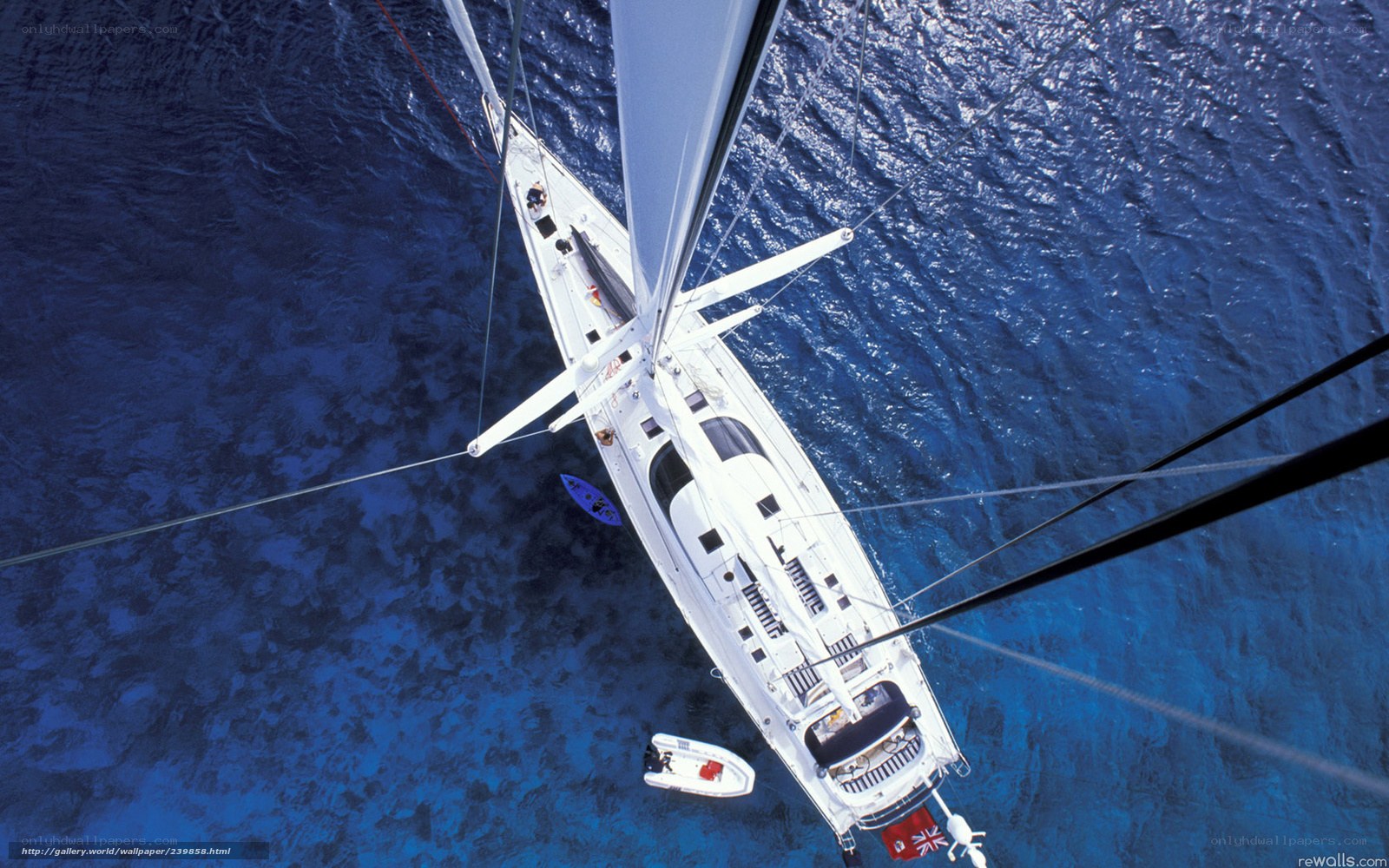 Sailboat from above on blue sea