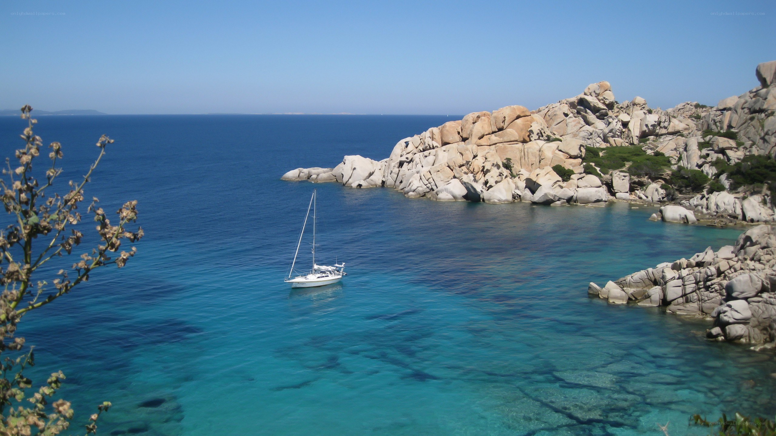 Sailboat in a rocky cove