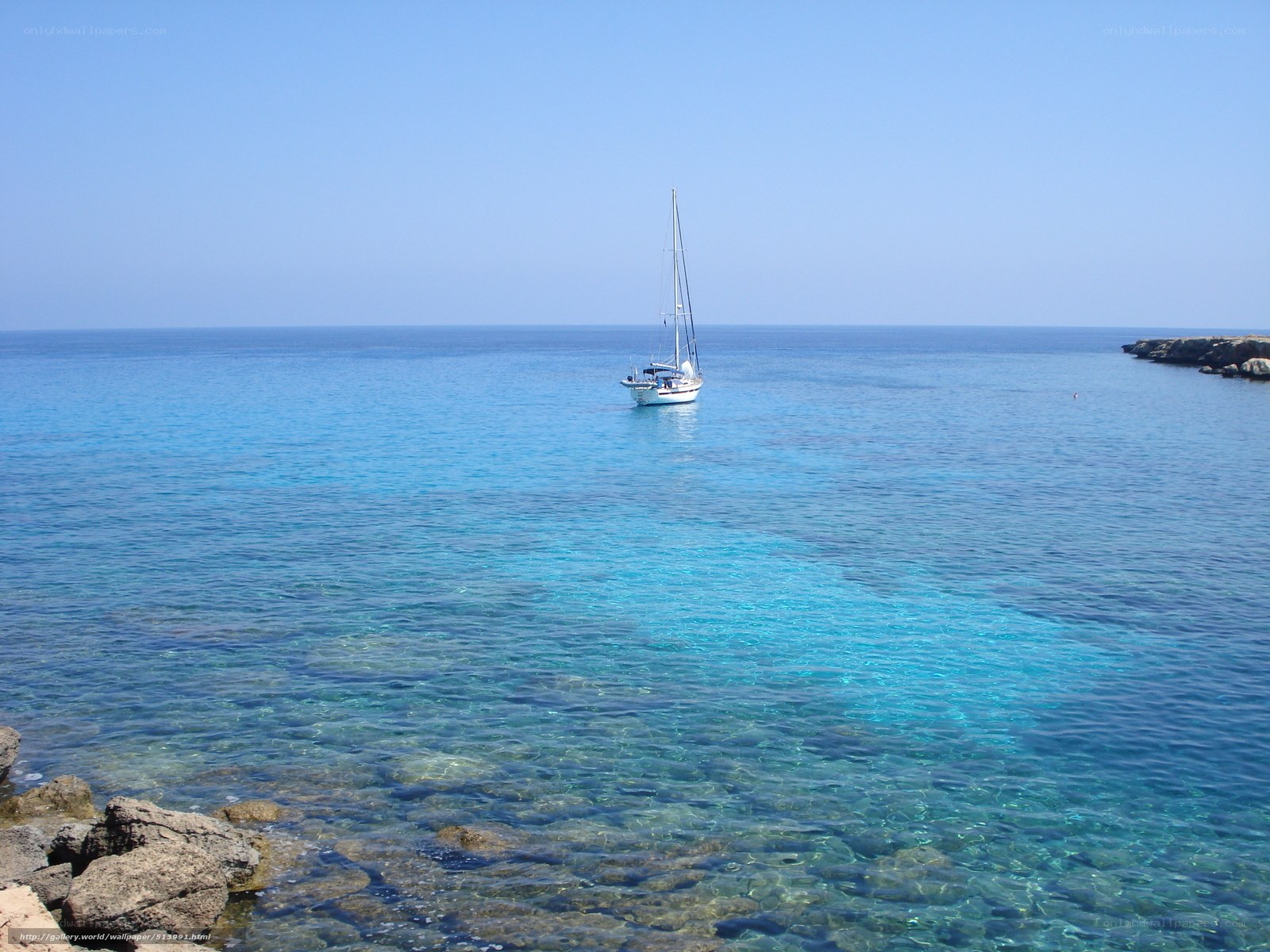 Sailboat in clear blue sea
