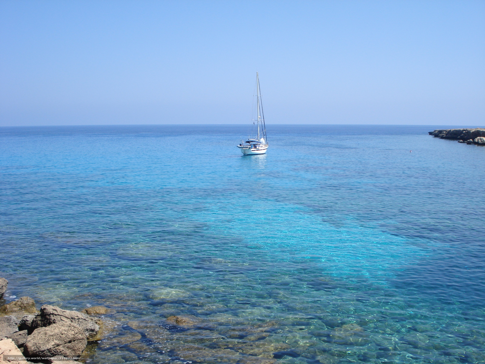 Sailboat in clear blue sea