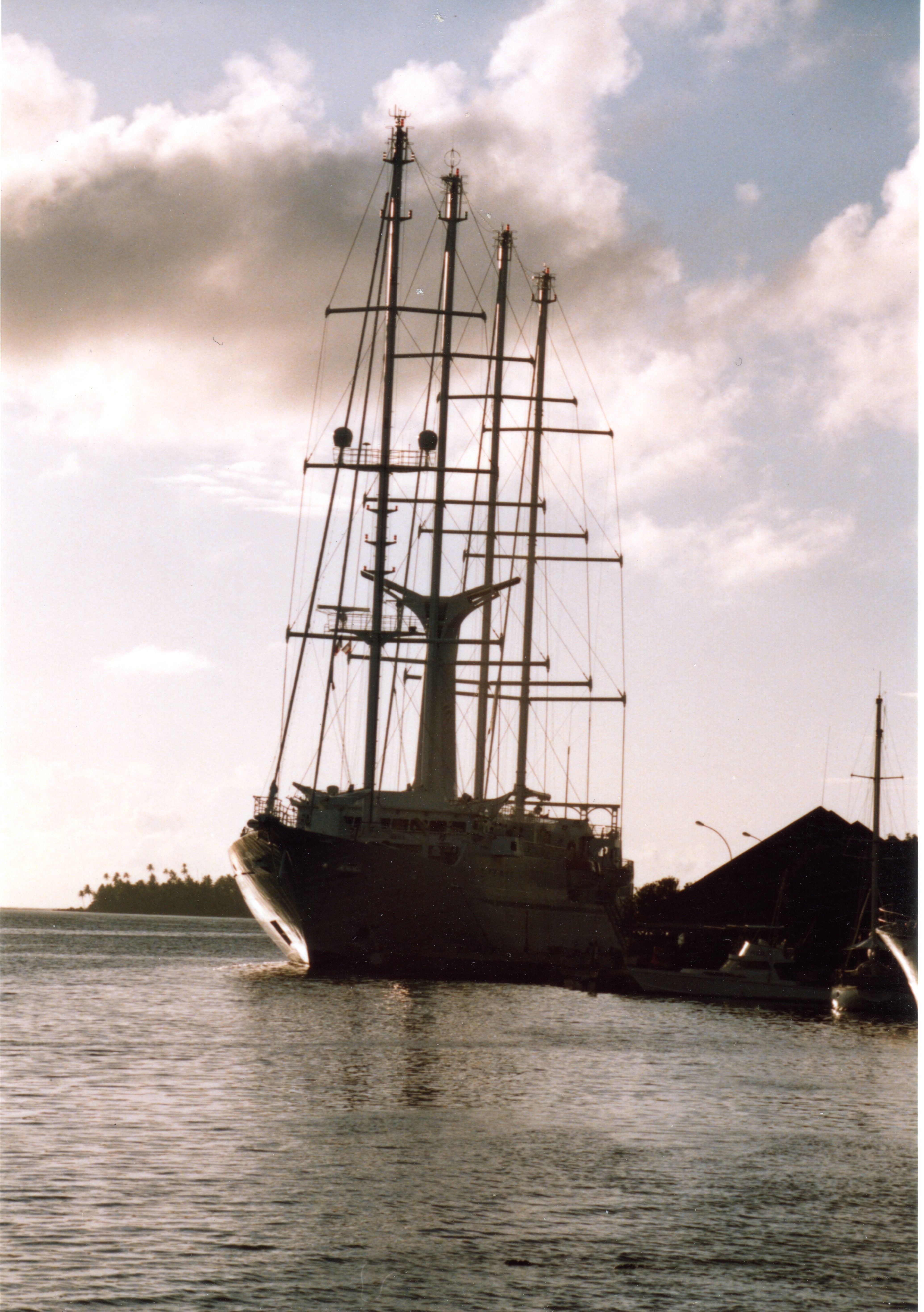 sailboat in harbor at sunset