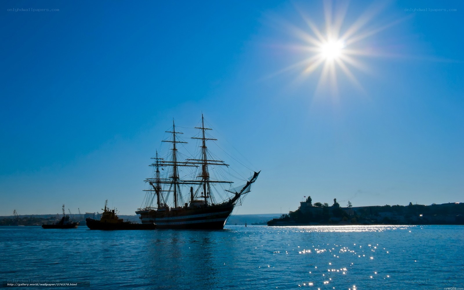 Sailboat in harbor at sunset