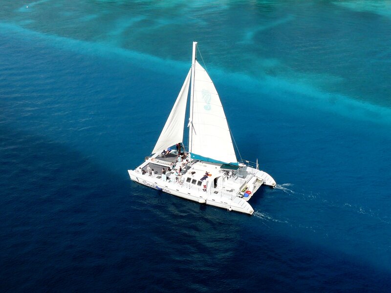 Sailboat in Ocean — Blue, Serene, Afternoon, Photograph, People