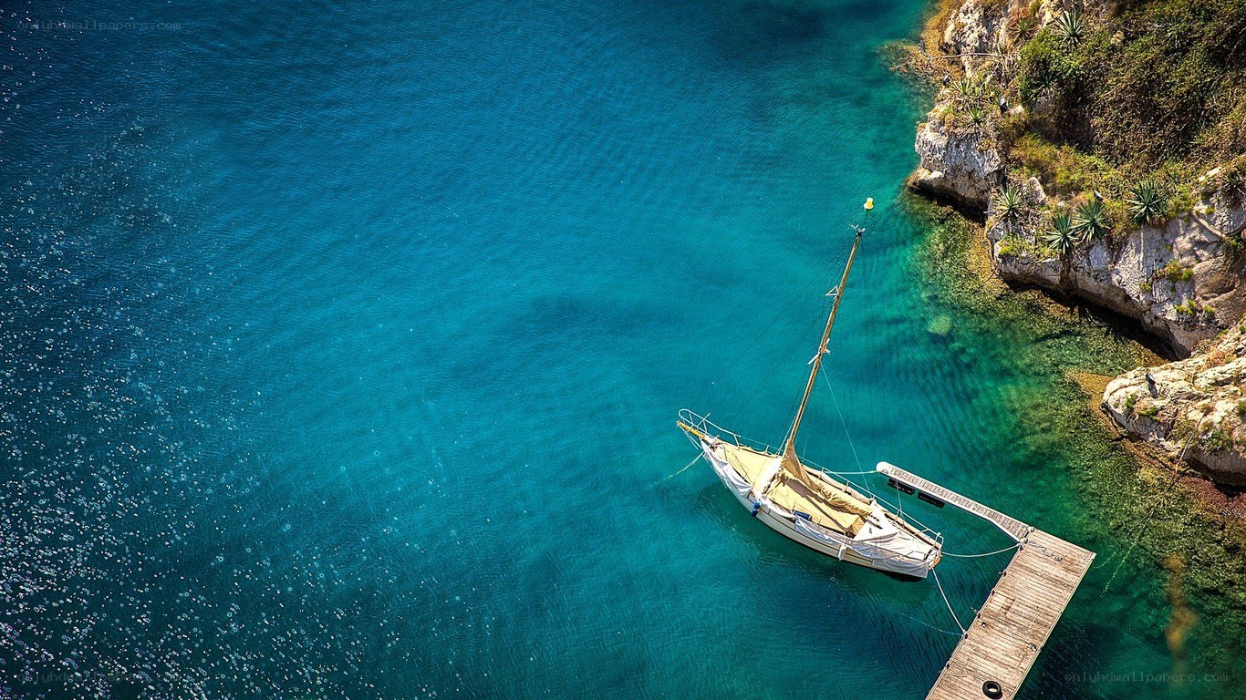 Sailboat in turquoise cove
