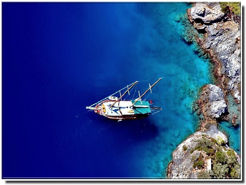 Sailboat in turquoise cove