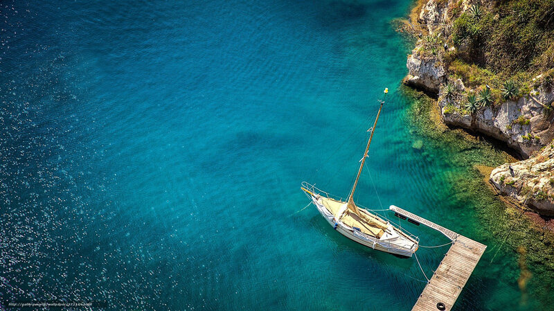 Sailboat in turquoise cove