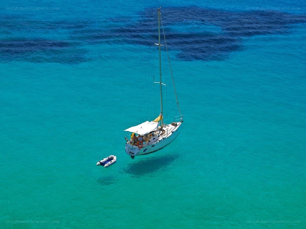 Sailboat in turquoise water