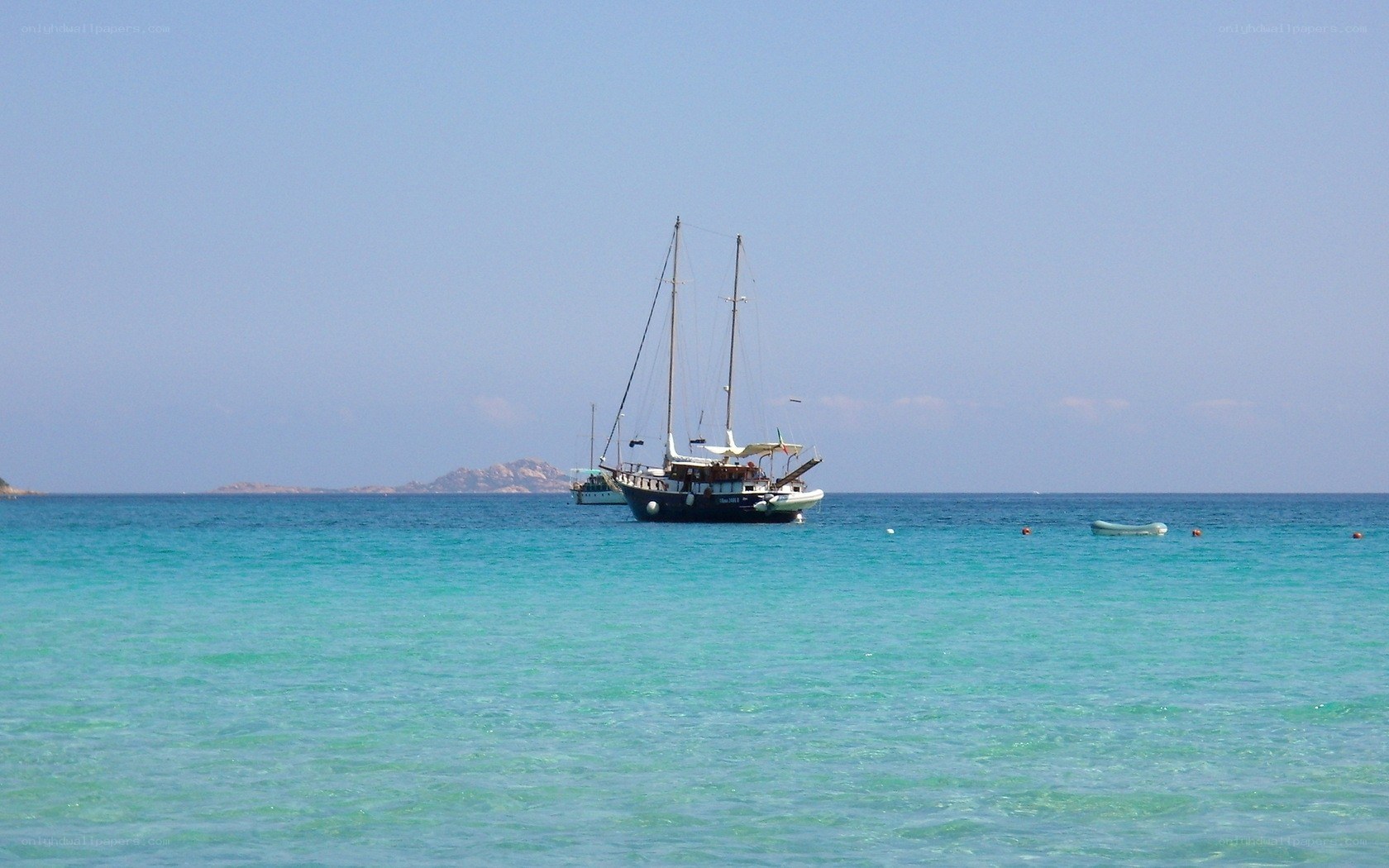 Sailboat in turquoise water