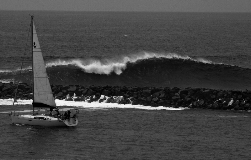 Sailboat near breaking wave
