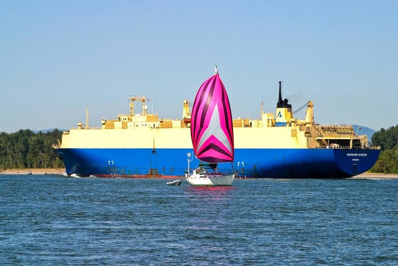 Sailboat Near Cargo Ship