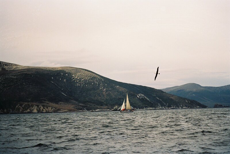 Sailboat near coastal hills