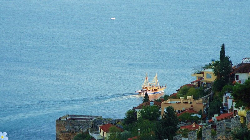 Sailboat Near Coastal Town