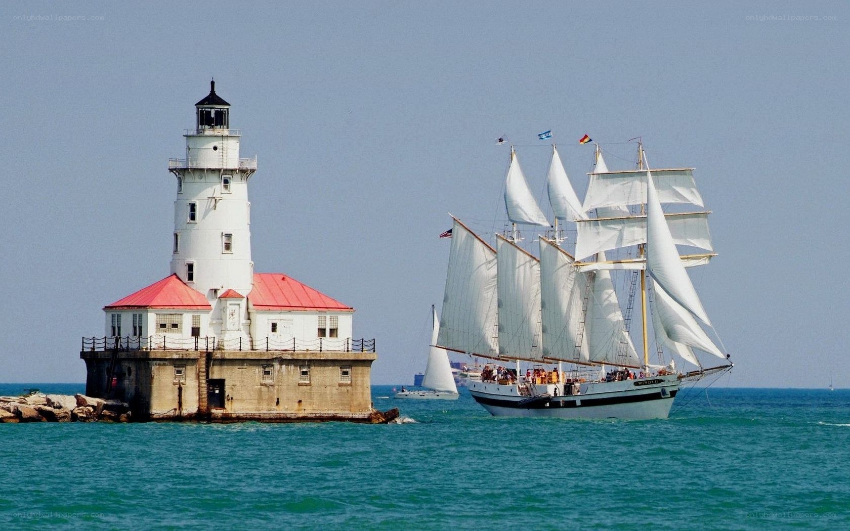 Sailboat near lighthouse