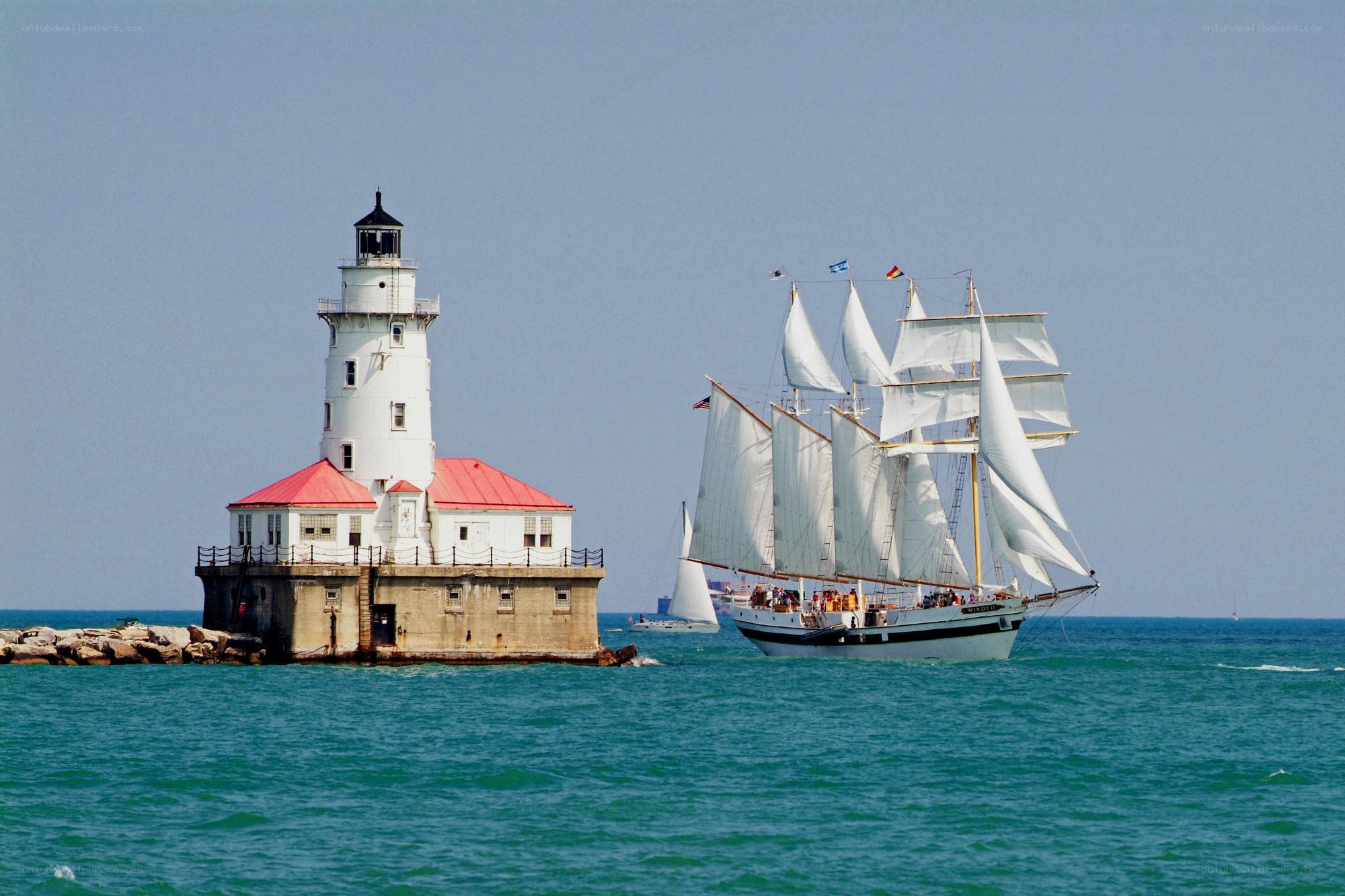 Sailboat near lighthouse