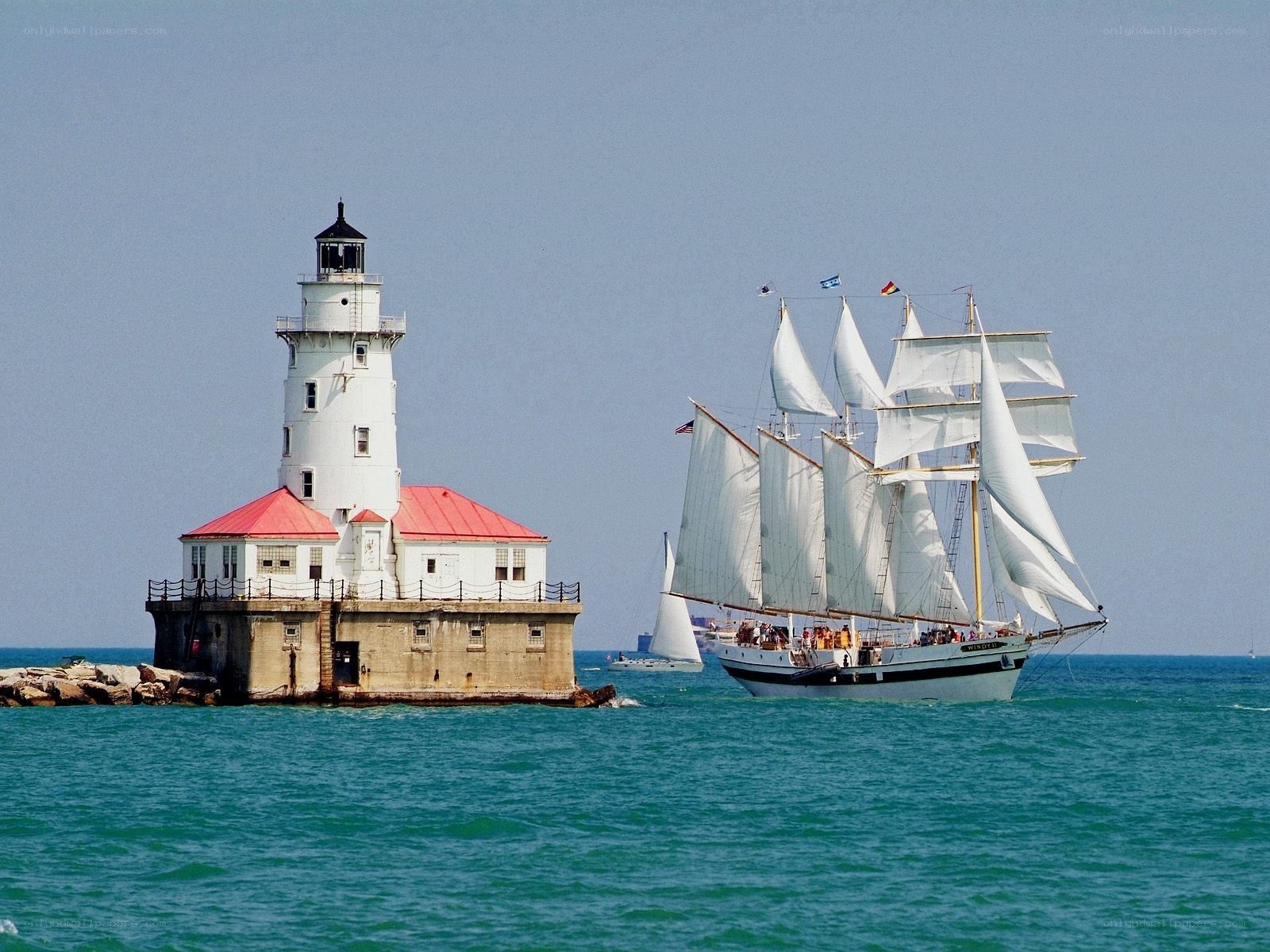 Sailboat near lighthouse