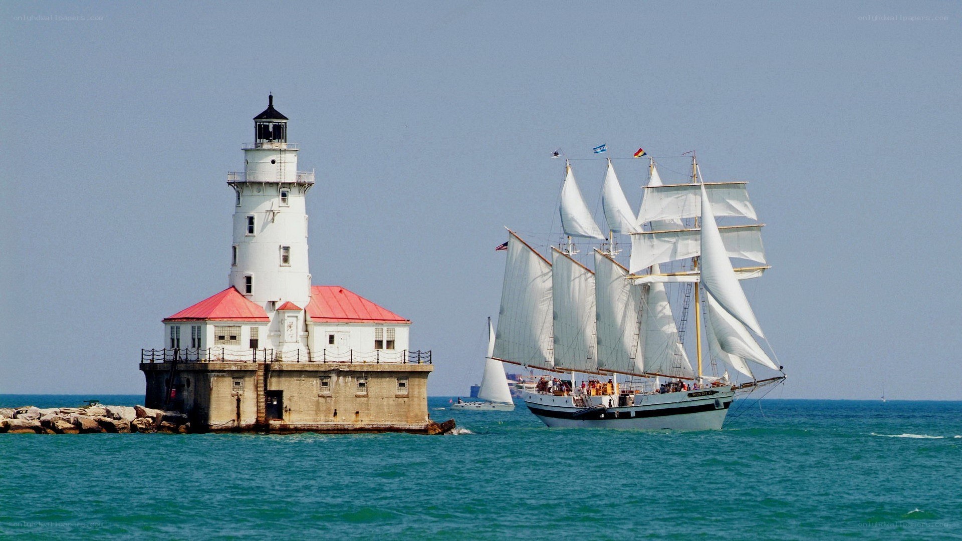 sailboat near lighthouse