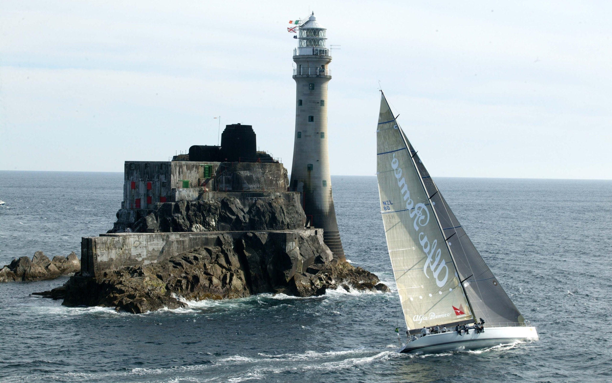 sailboat near lighthouse