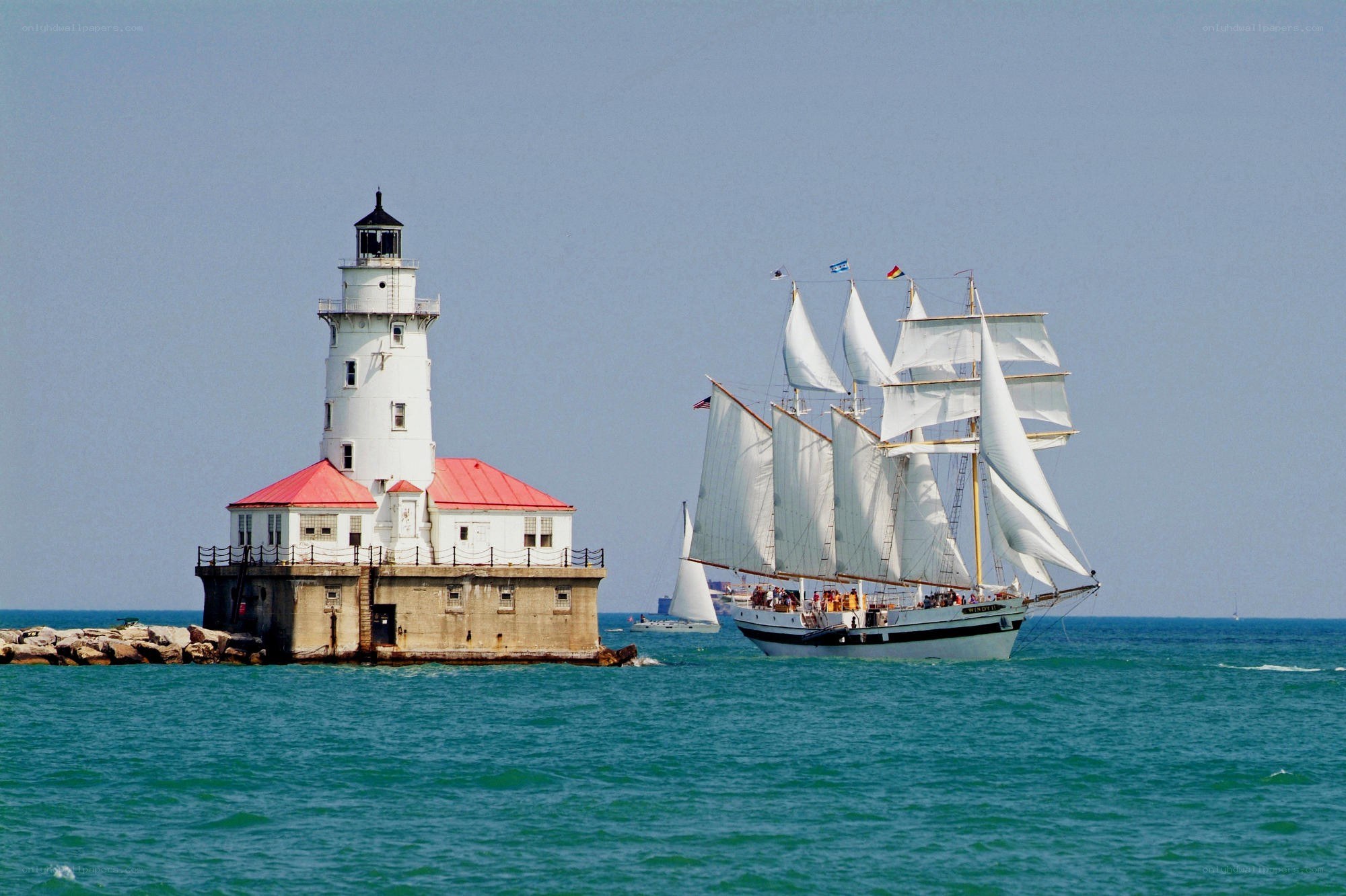 Sailboat near lighthouse
