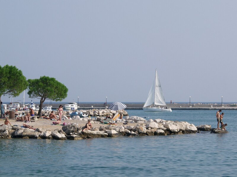 Sailboat near rocky beach