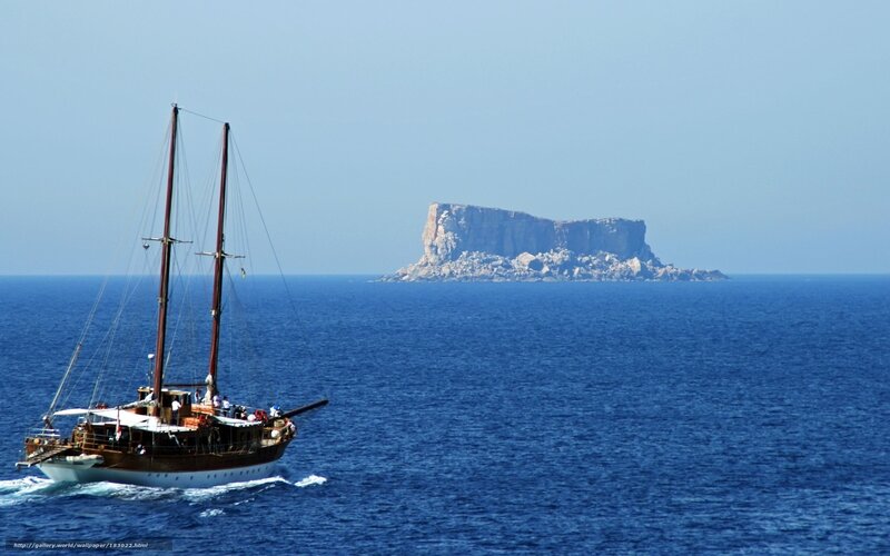 Sailboat near rocky island