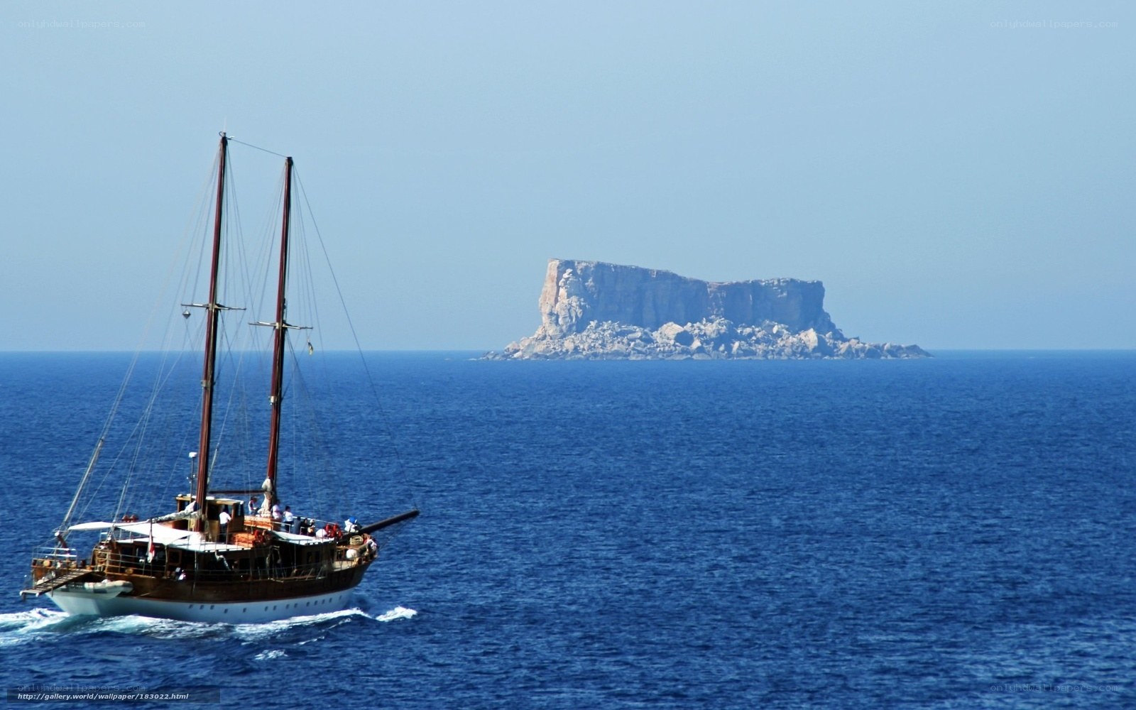 Sailboat near rocky island