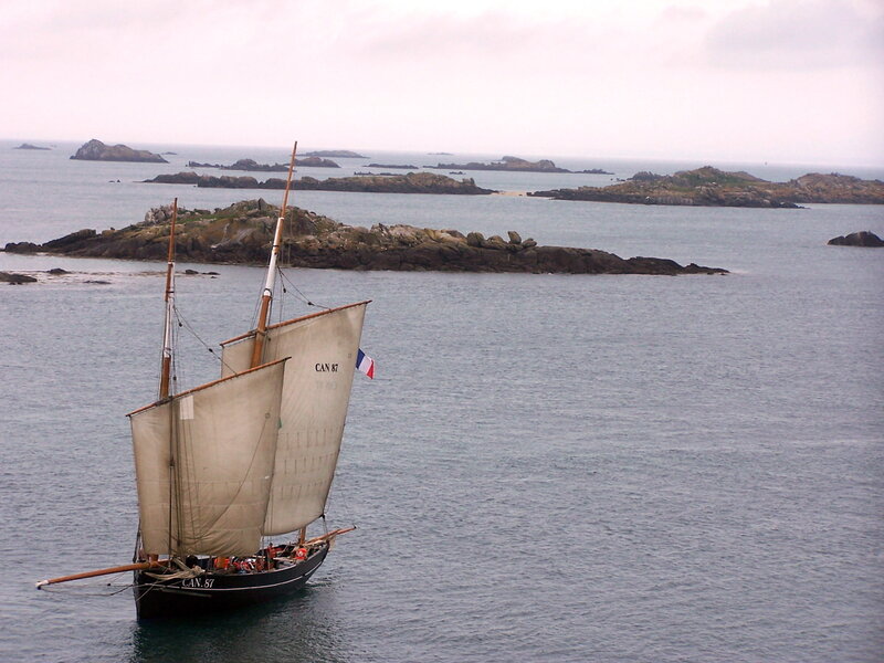 Sailboat near rocky islands