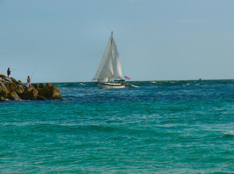 Sailboat near rocky shore