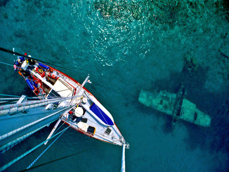 Sailboat Near Shipwreck — Blue, Serene