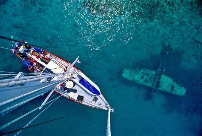 Sailboat near shipwreck