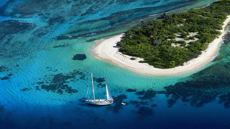 sailboat near tropical island